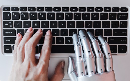 Robot hands and fingers point to laptop button advisor chatbot robotic artificial intelligence concept